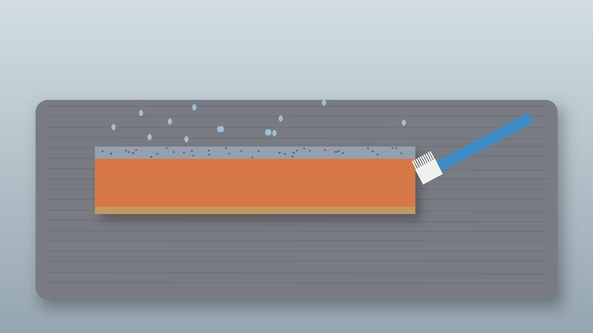 Illustration of a two-sided whetstone being cleaned with water and a brush