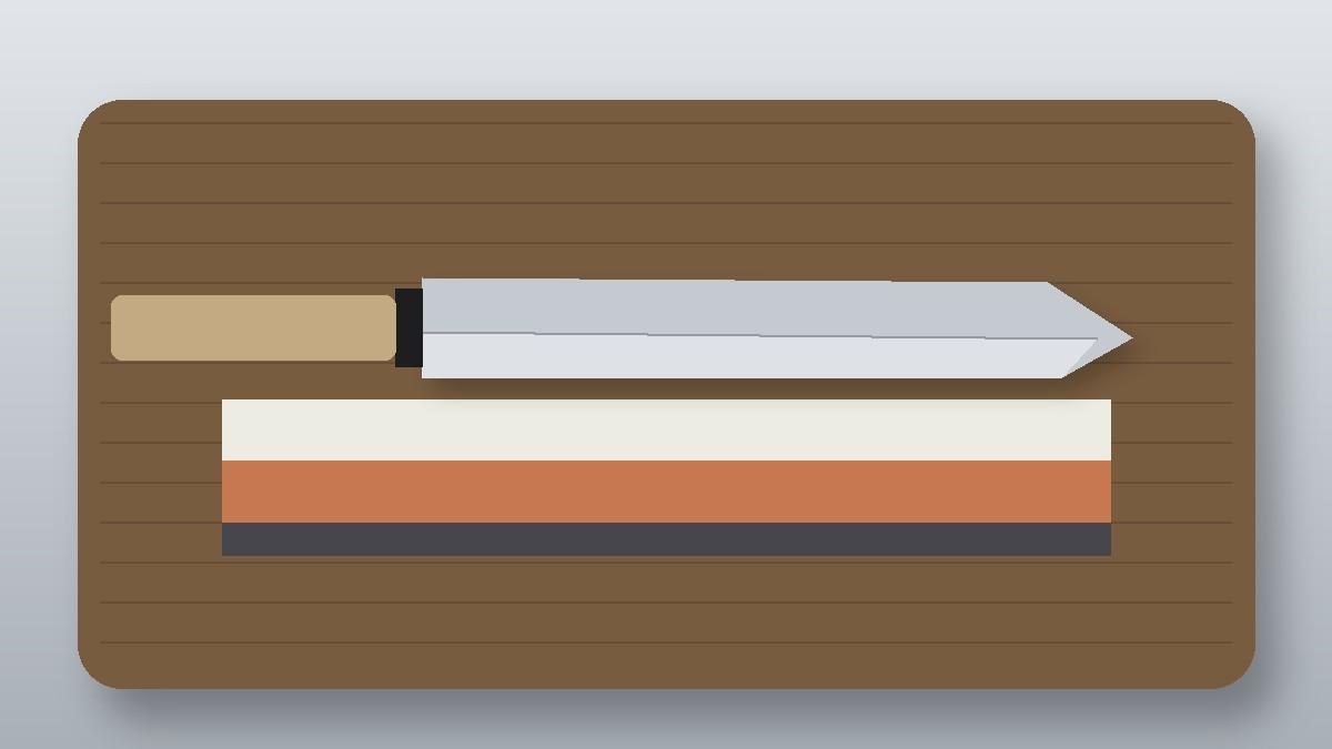 Long single-bevel yanagiba sushi knife above a two-sided whetstone